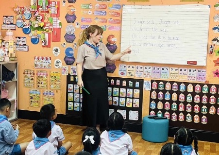 Alice teaching the children Jingle Bells